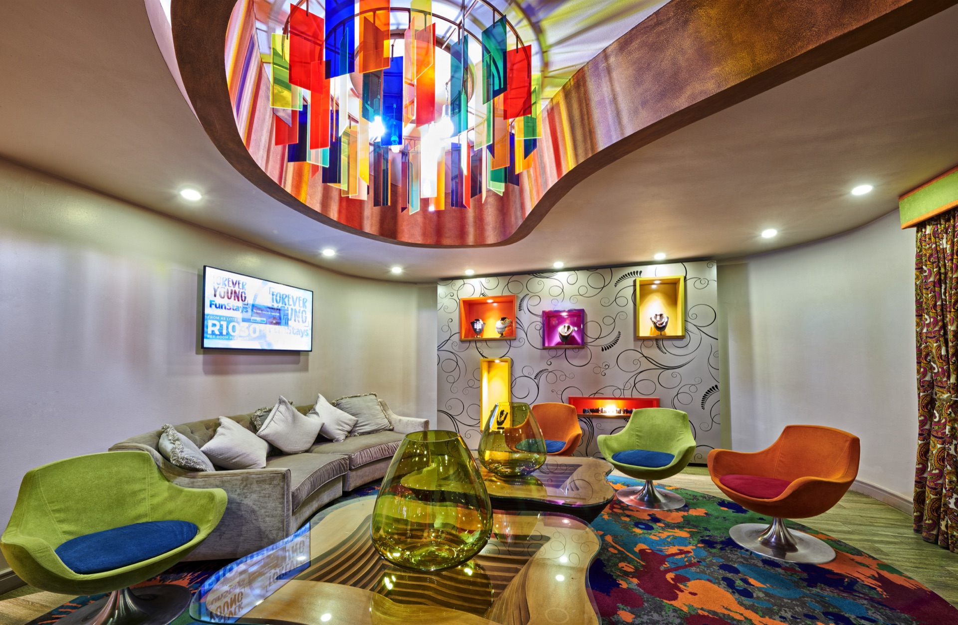 Colourful lounge with stained-glass chandelier at Peermont Metcourt Hotel Thaba Moshate