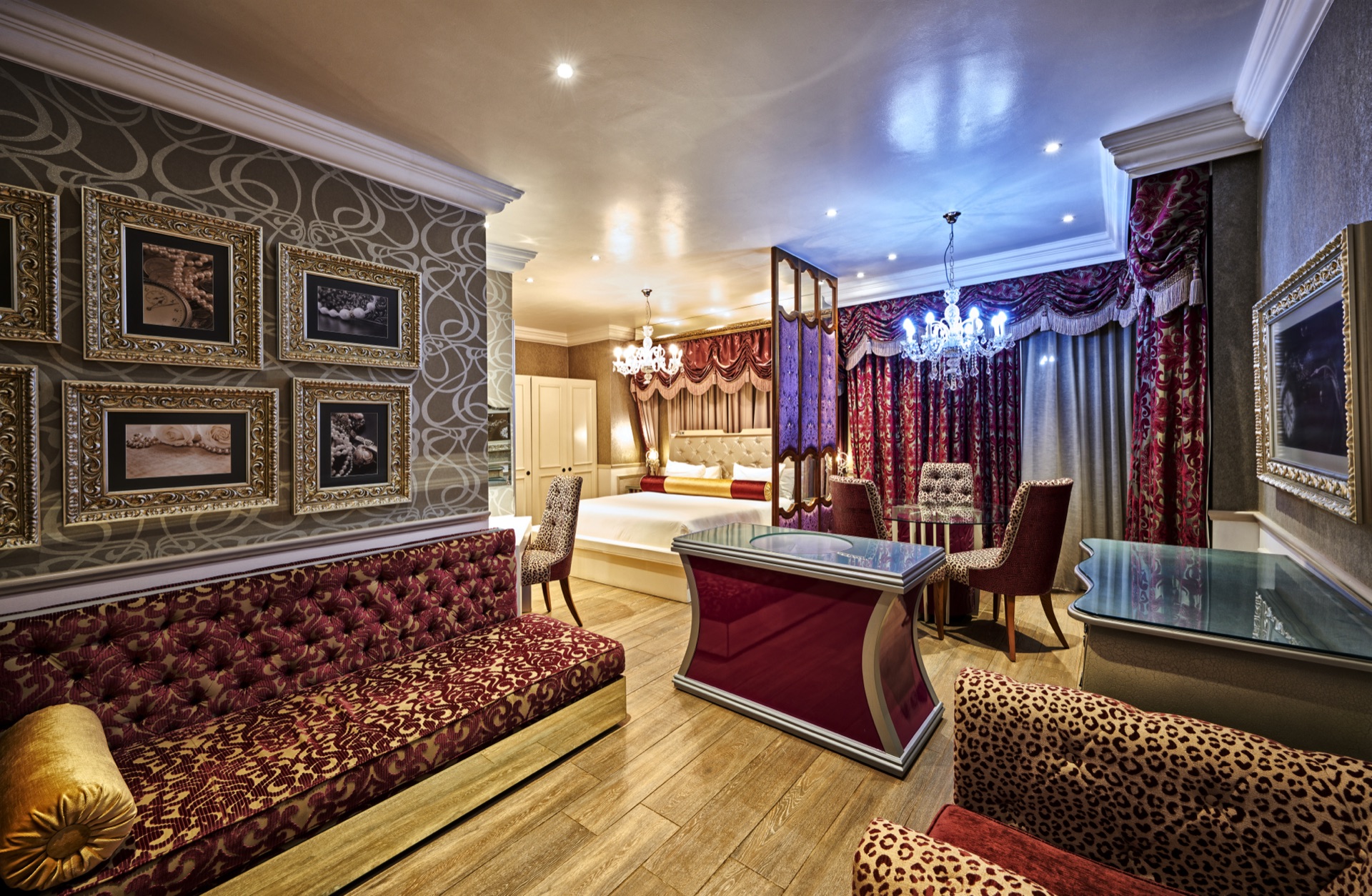 Opulent suite with draped four-poster bed and framed artwork at Thaba Moshate, Burgersfort