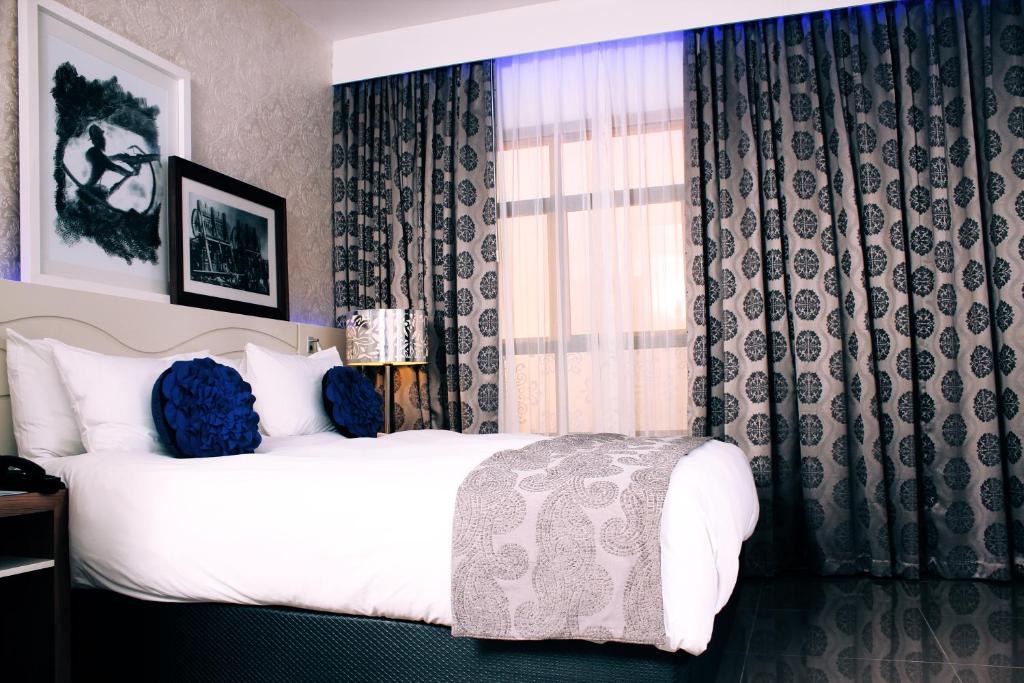 Superior King Room with blue mood lighting at Metcourt Thaba Moshate