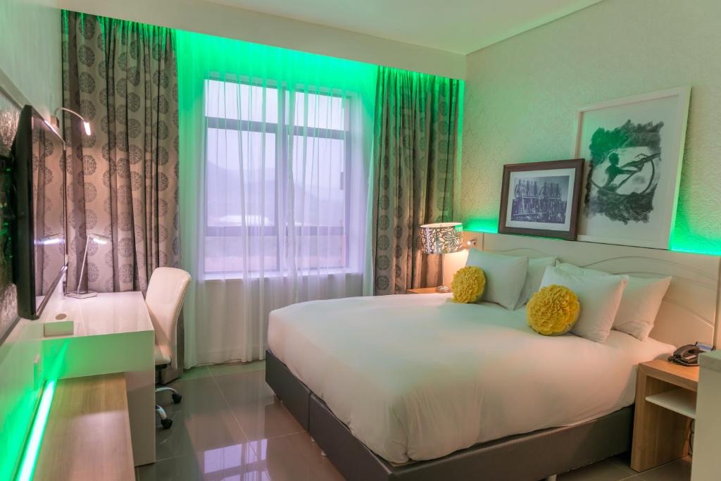 Superior King Room with green mood lighting at Metcourt Thaba Moshate