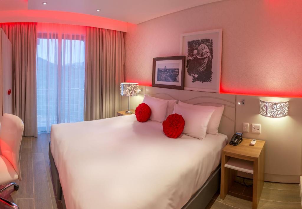 Superior King Room with red mood lighting at Metcourt Thaba Moshate